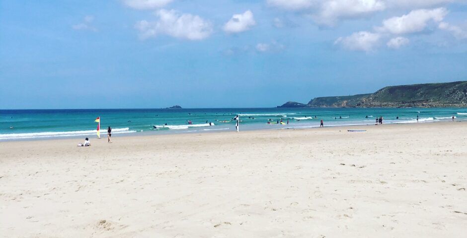 Image of Sennen beach on a sunny day to show hot weather and that Microcomms Professional Services can help prepare businesses for extreme weather conditions so there is no business interruption