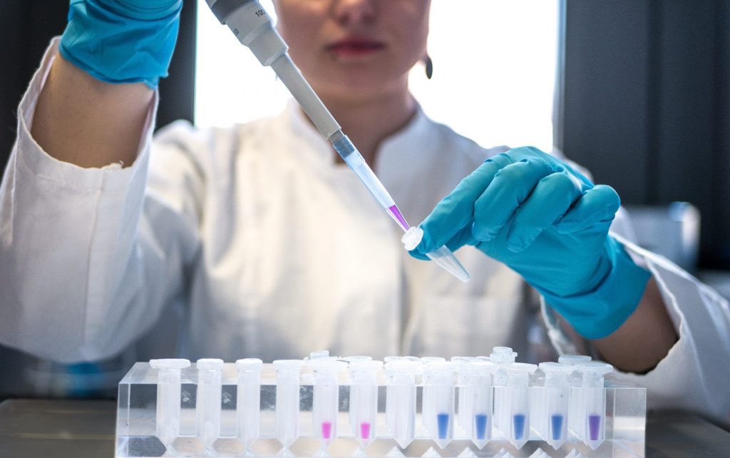 Scientist using a pipette in a lab