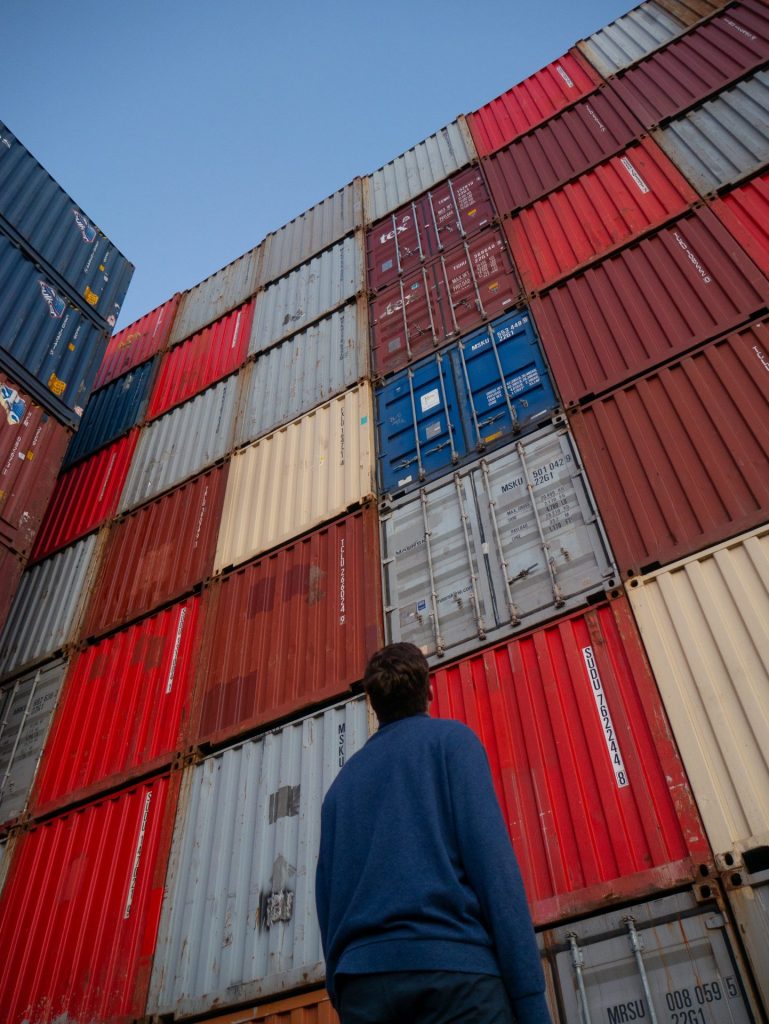 Marine Technology with Microcomms: Man looking at shipping containers. 
