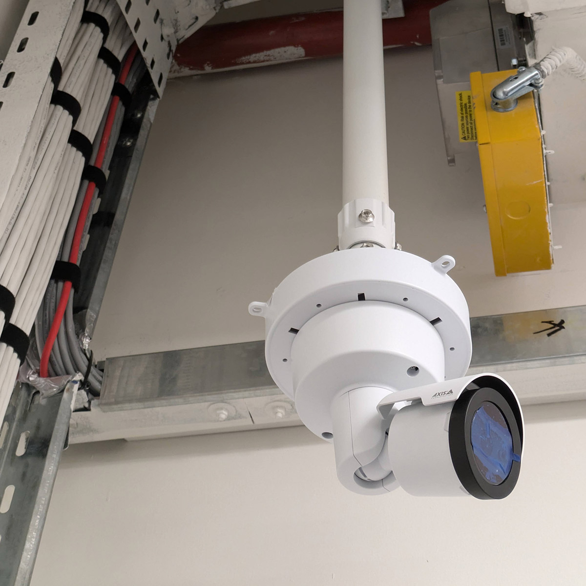 Workman fitting CCTV to the top of a tall pole